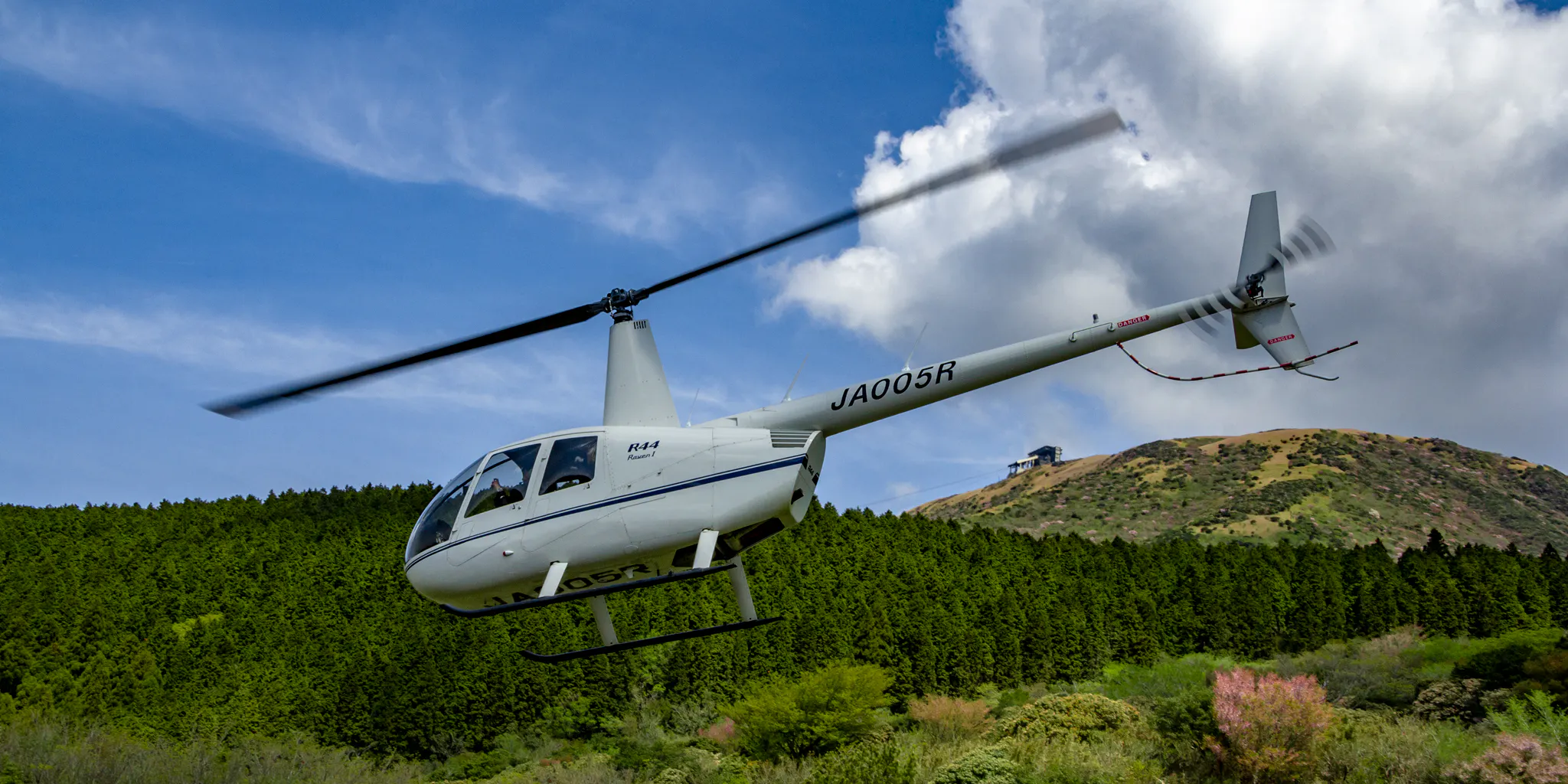 Sightseeing helicopter flying over the forest