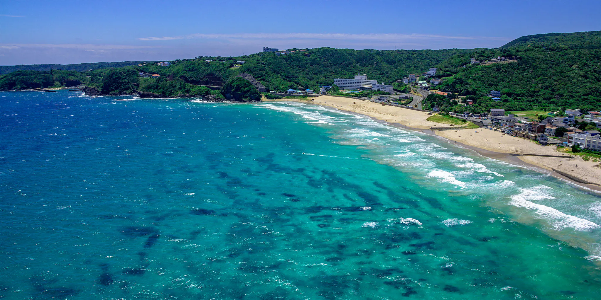 Aerial view of Shirahama Beach's crescent white sand and turquoise sea