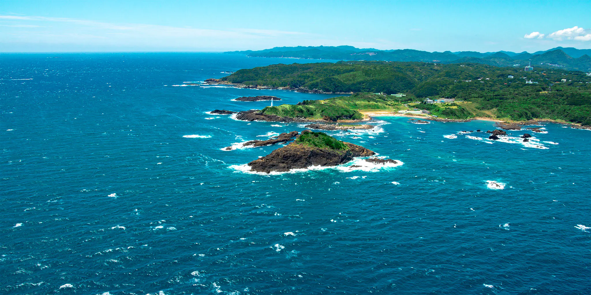 Tsumekizaki cape with its white lighthouse and scattered rock islets