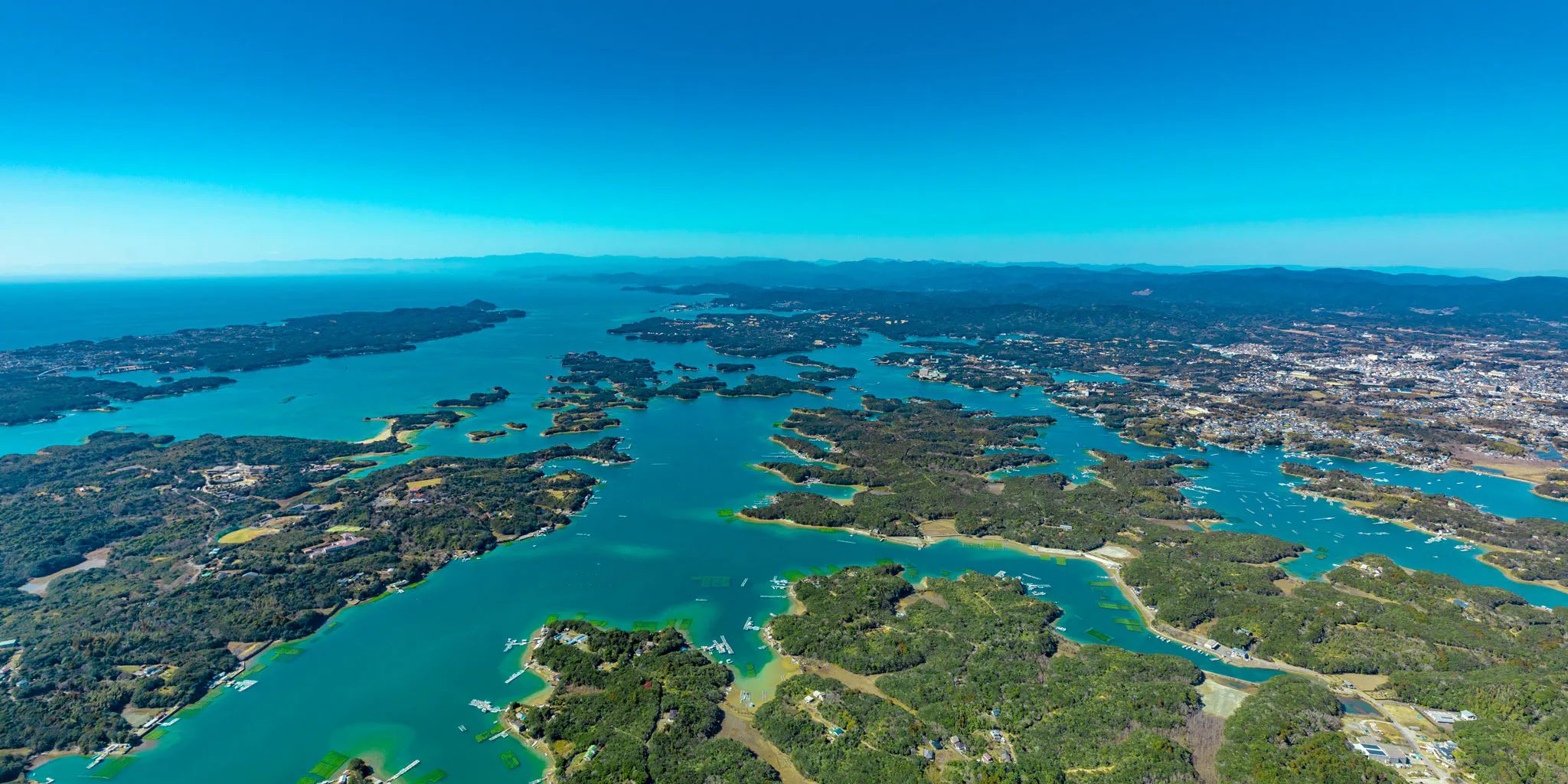 Aerial view of Ago Bay's ria coastline dotted with green islands