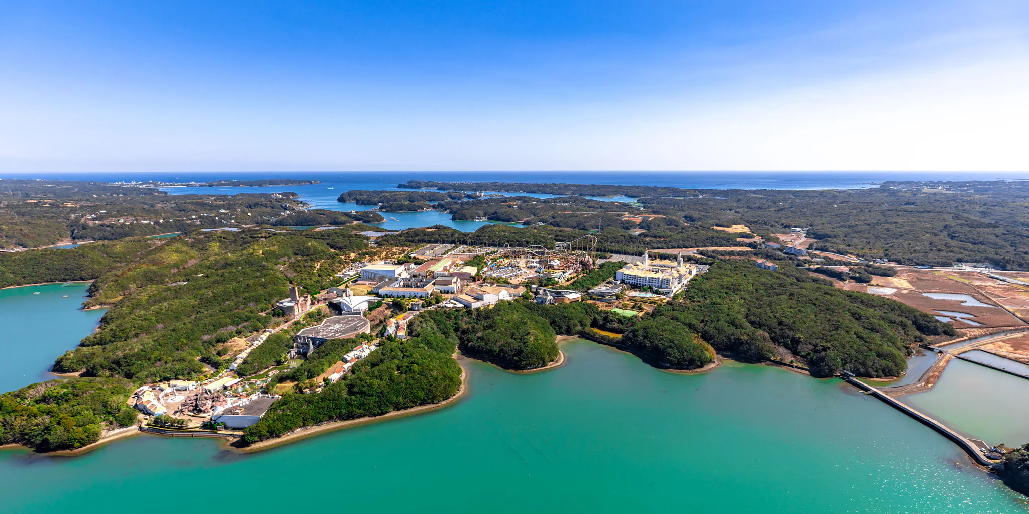 Aerial view of a coastal theme park resembling Shima Spain Village