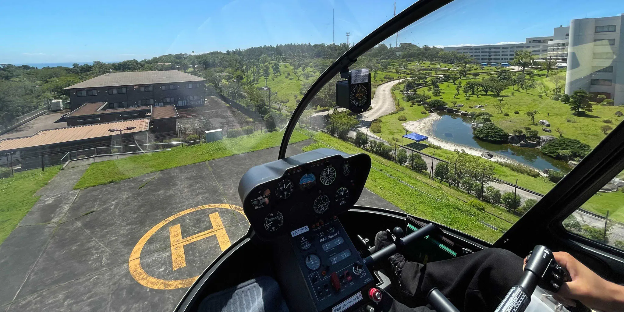 View of a garden and helipad from the helicopter cockpit