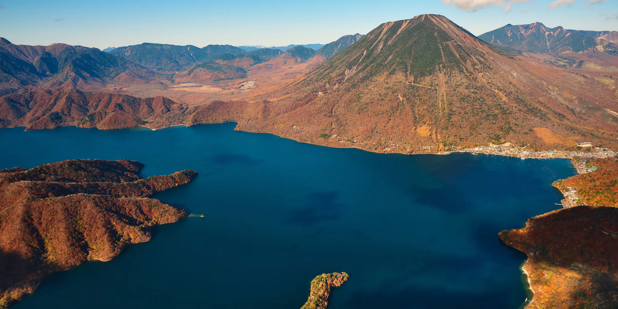 Aerial view of Lake Chuzenji surrounded by Mt. Nantai and autumn-colored mountains