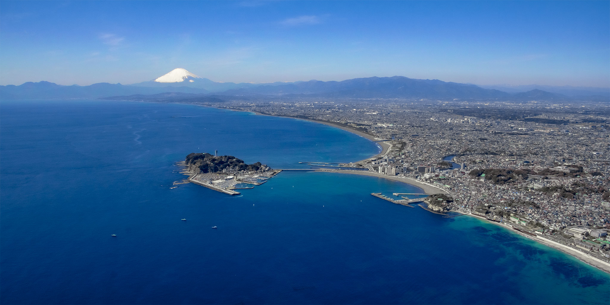 ヘリコプターで上空から見下ろす江ノ島と富士山